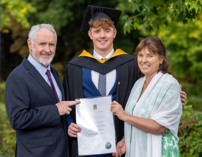 Finn McGeever with his parents at his graduation