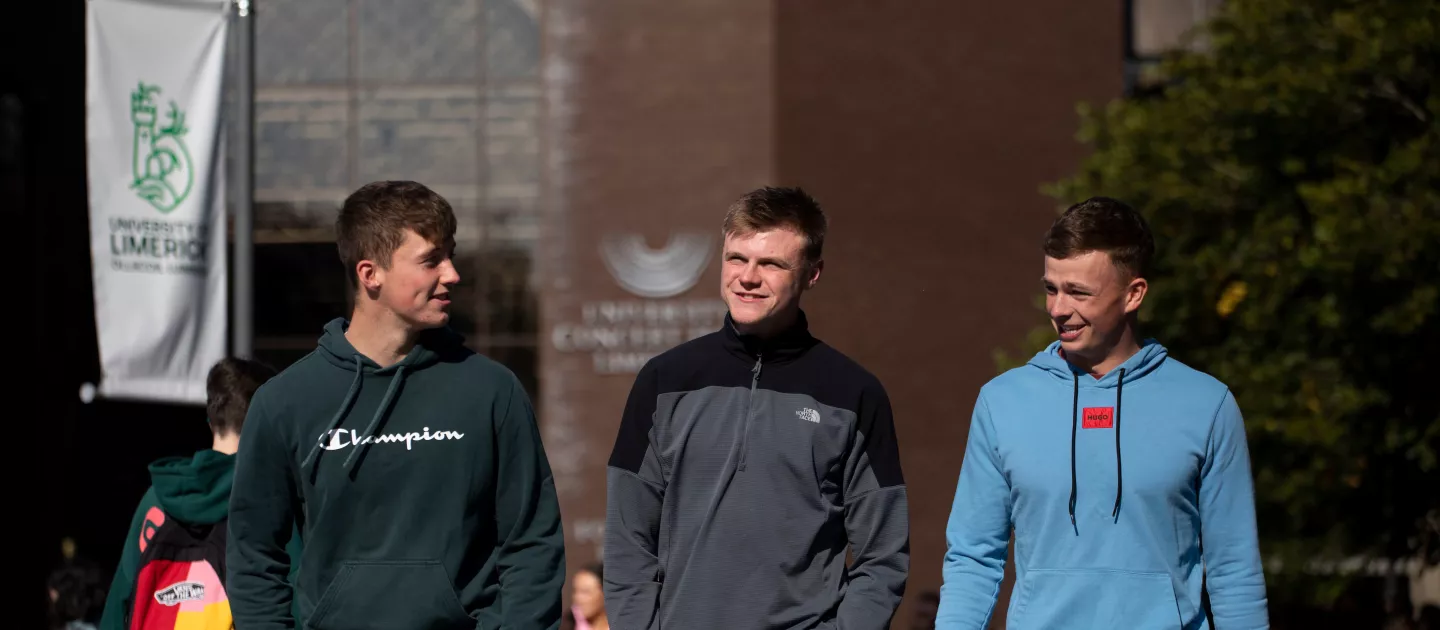 3 students walking and talking during orientation