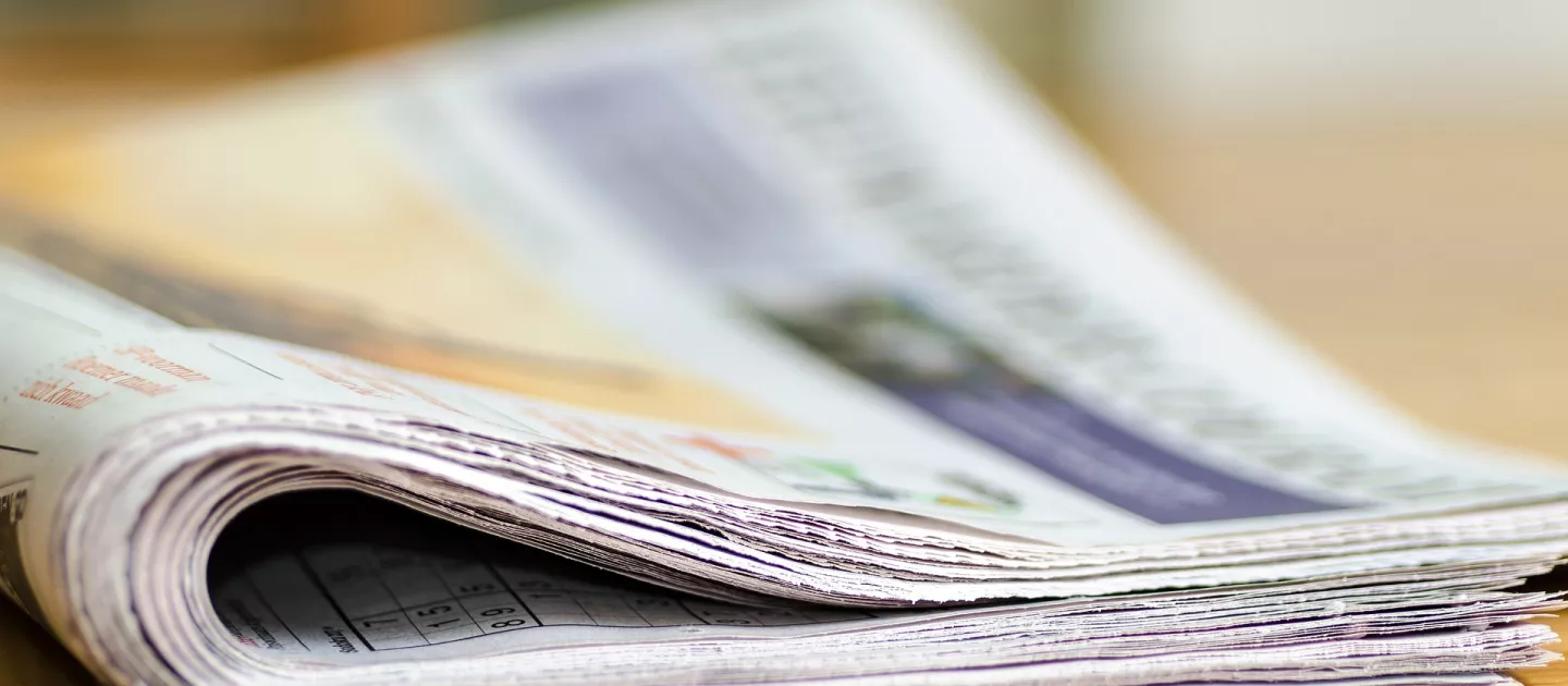 image shows newspapers in a bundle 