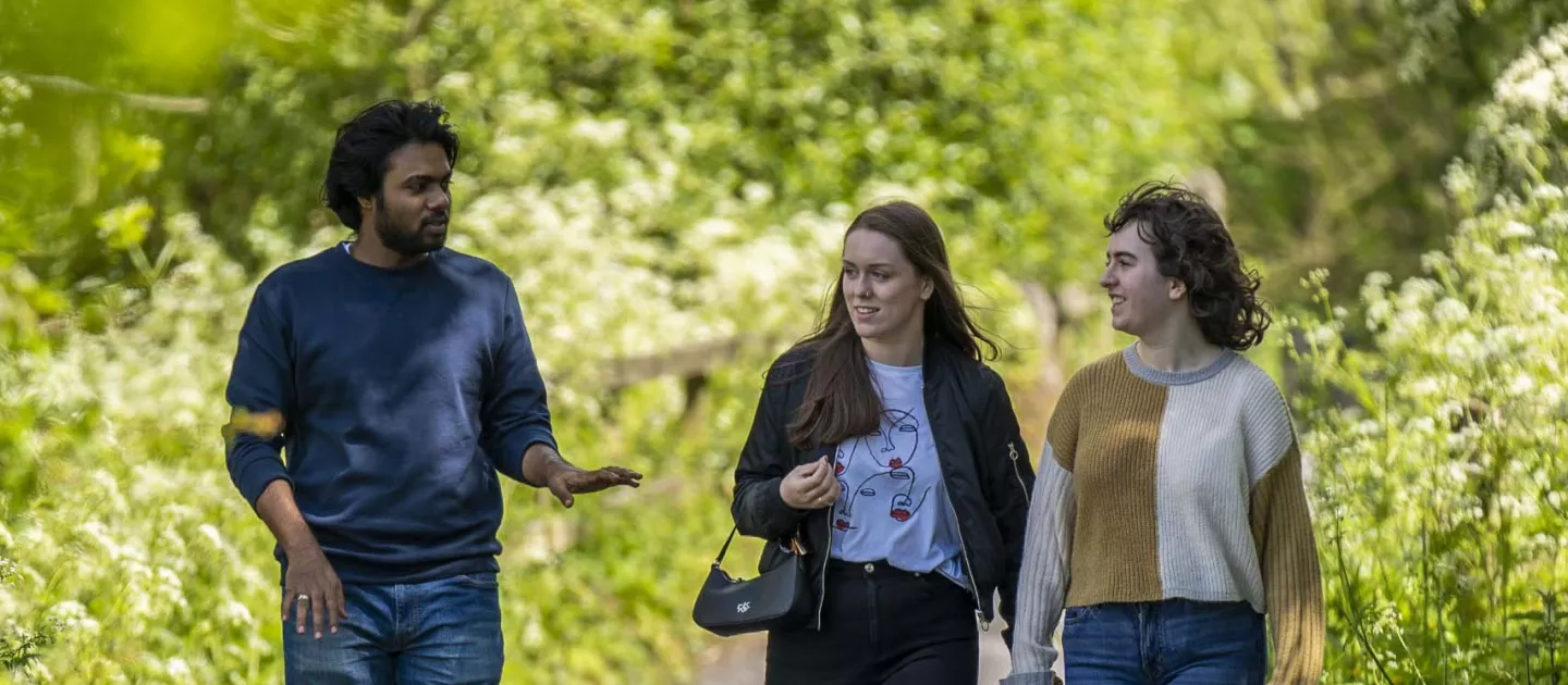 Students walking on the riverbank