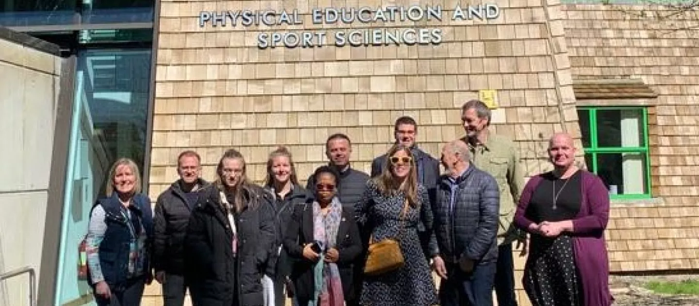 Group picture of Interact Project members in front of the PESS building logo