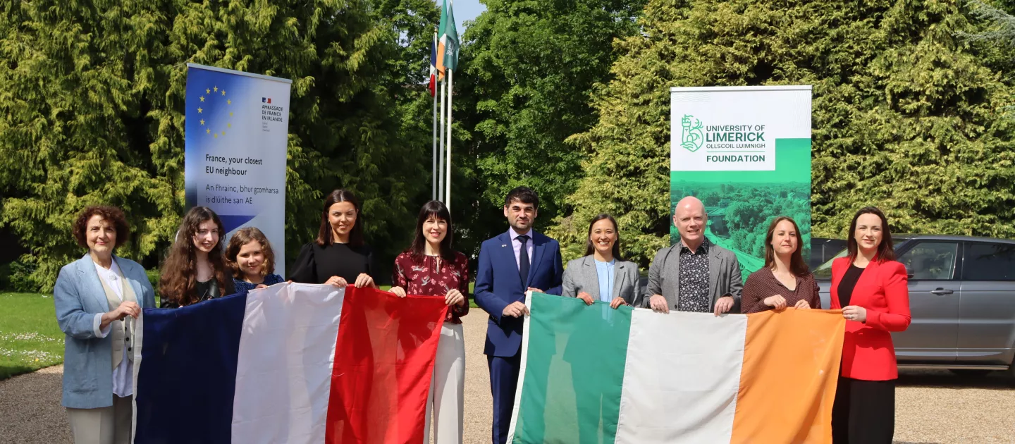 Group photo with people holding Irish and French flags