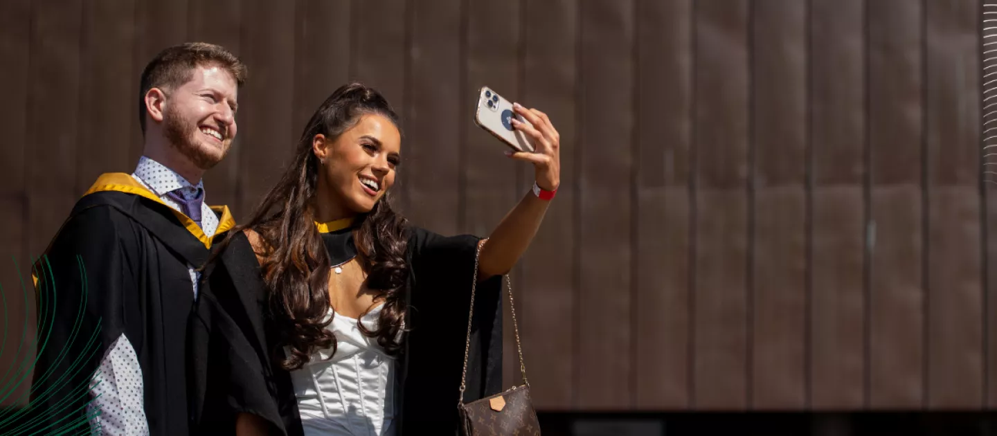 two UL students taking a selfie with a smartphone