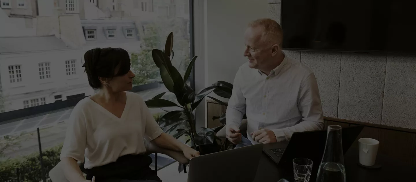 Man and Women Chatting in an office