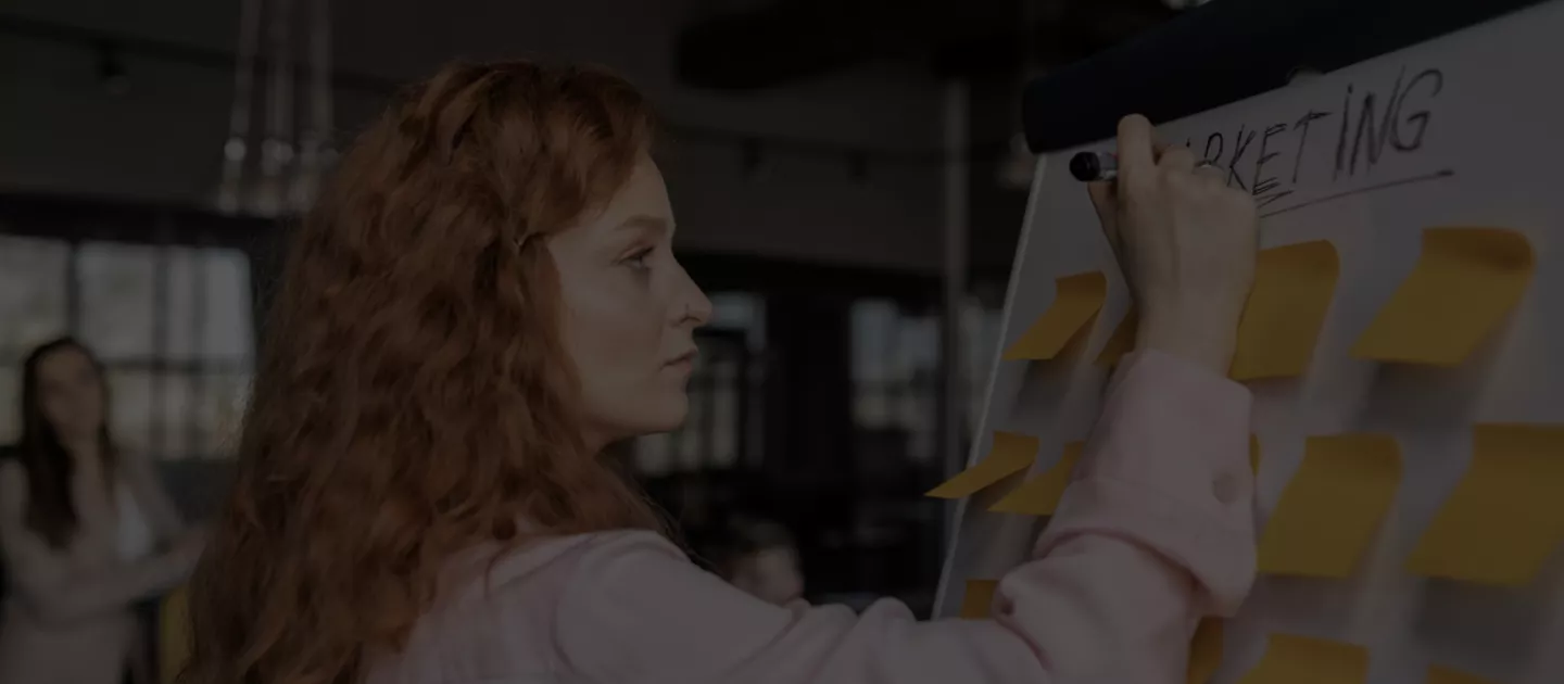 Banner image showing a women at a whiteboard