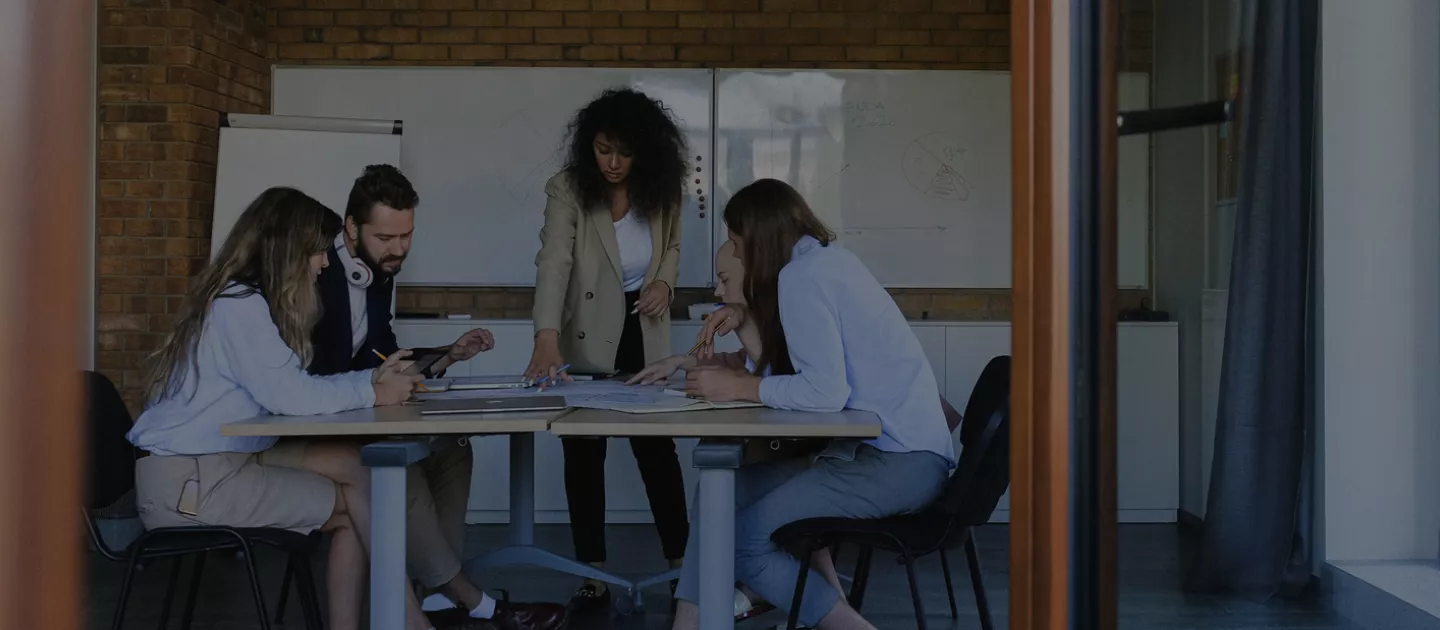 Group of professional gathered around a desk