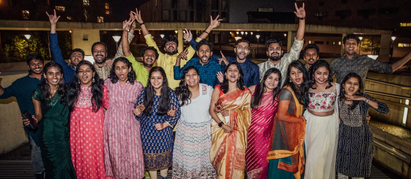 Photo of Diwali 2023 guests smiling outside in their traditional clothing