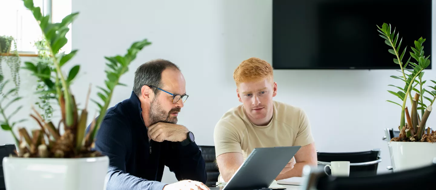 Image of two people looking at a laptop in the Nexus Innovation Centre