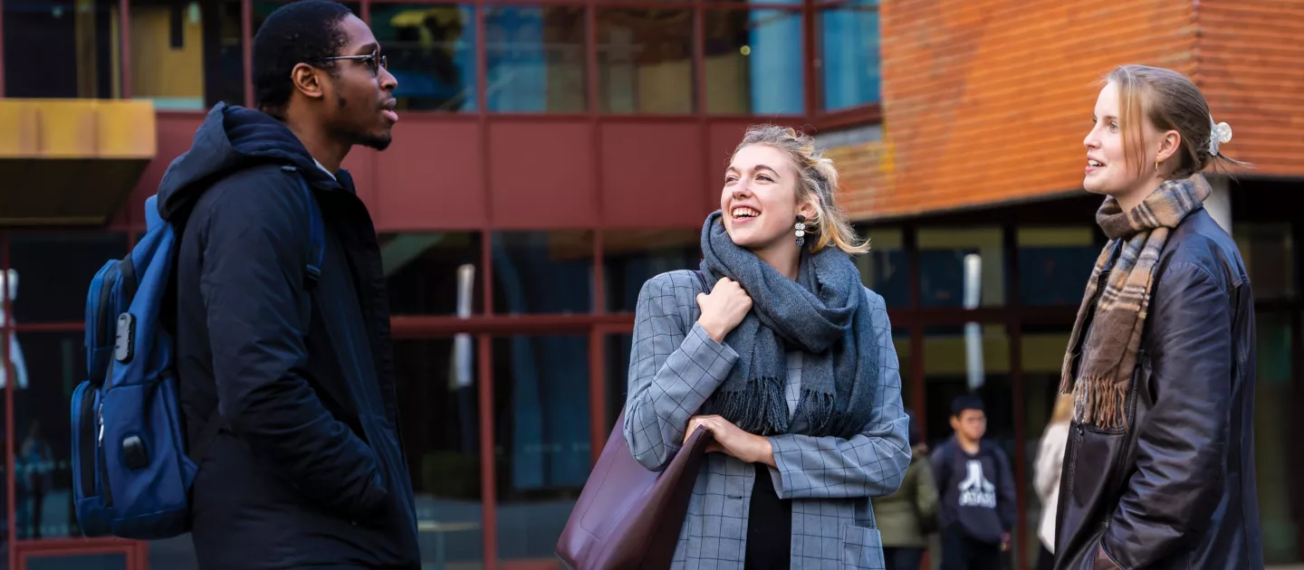 3 Students talking outside IWAMD