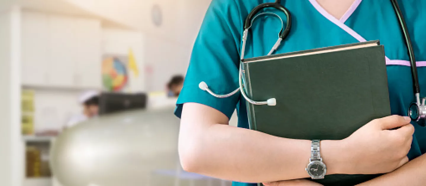 Person with stethoscope and laptop