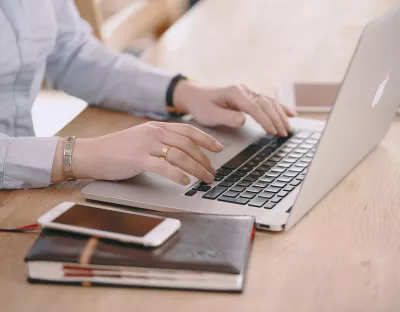 someone typing on a laptop