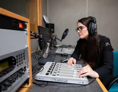 A UL journalism student broadcasting from a media lab