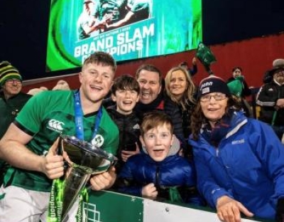 Patrick Campbell holding a trophy with his family