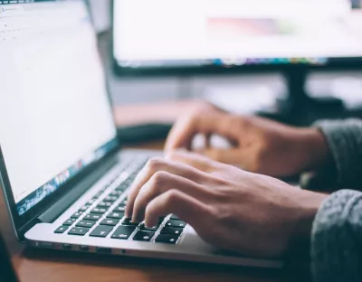 hands typing on laptop