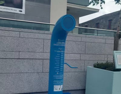 An image of the Poetry Jukebox in Galway. It is a blue pipe with a handle and a speaker on top