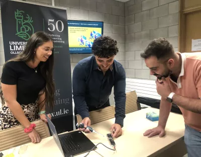 A group looking at a computer in UL