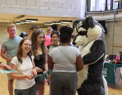 Photo of Wolfie with students at the Student Support fair for Orientation 2023