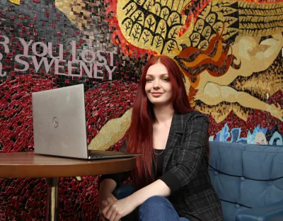 A picture of UL student Róisín Mitchell, sitting at her laptop