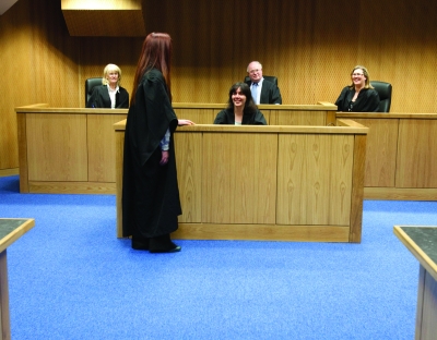 Students wearing legal robes in the UL moot court