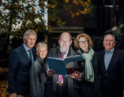 Some of UL's first graduates pictured with Martin Walsh, holding the book being launched on campus