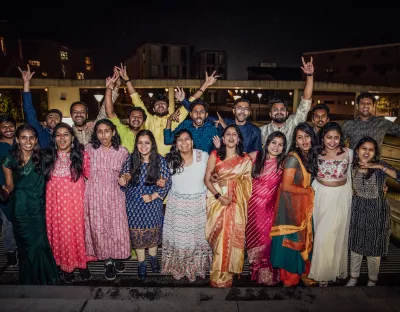 Photo of Diwali 2023 guests smiling outside in their traditional clothing