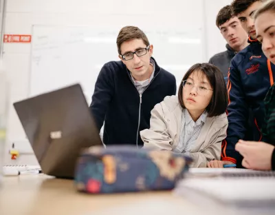 students looking at a laptop 