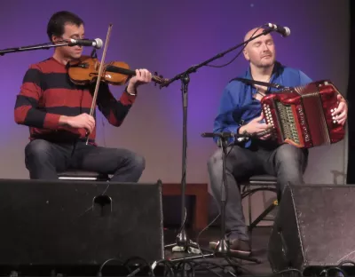 Two people on stage playing music