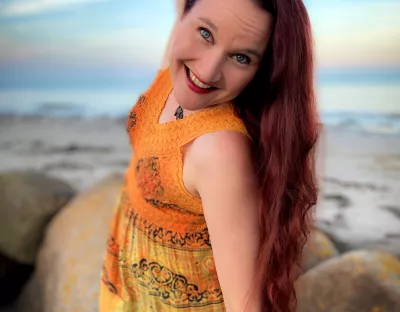 Smiling woman standing on rocks