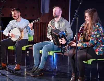 People on stage playing musical instruments