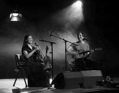 Two people on stage playing music