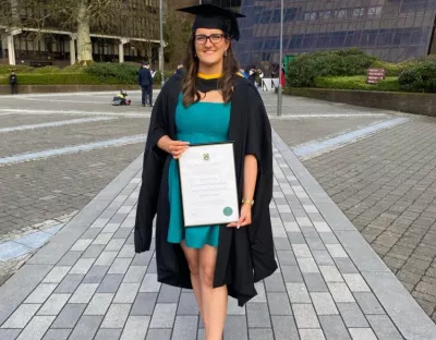 edel kearney, masters graduate, holding her parchment