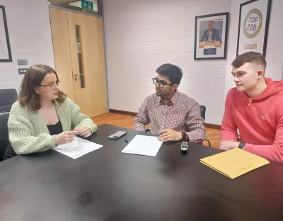 three chosen students discussing their internship in the school of law boardroom