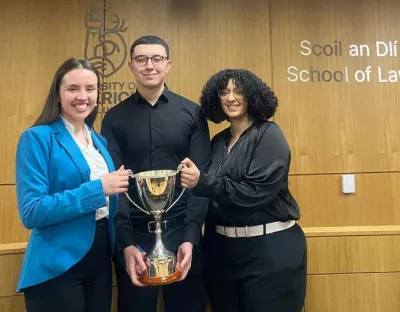 Emma Wright, Adham Mahdy and Wiame Kanane, winners, holding the trophy