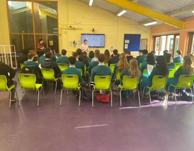 dr luke danagher and administrator kathleen coll speaking to a group of students in the library of castletroy college