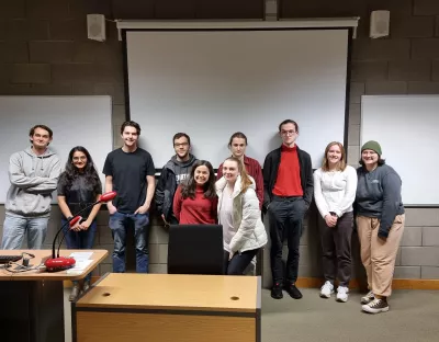 A group of students in a room with a guest speaker