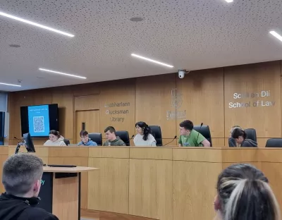 A group of students seated at the UL moot court room participating in a debate