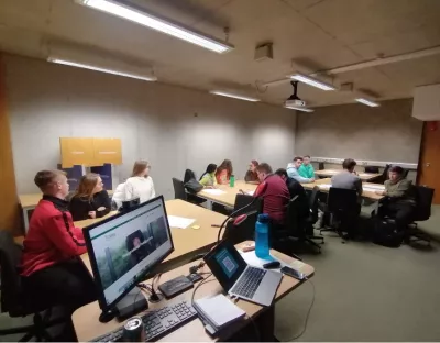 A group of students in a room brainstorming ideas