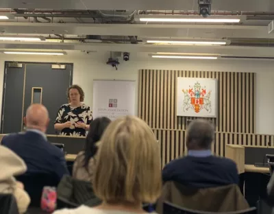 Professor Jennifer Schweppe in the Ulster University Moot Courtroom, speaking to a crowd