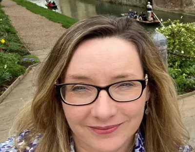 Dr Una Woods in front of the canal in Cambridge University.