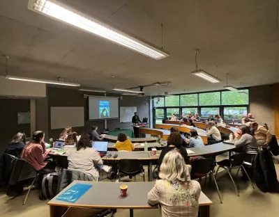 Lecture room with students working at the conference