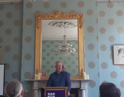 a man standing at the podium speaking at a limerick civic trust event