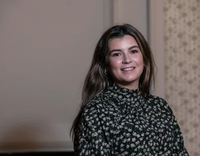 Headshot of woman standing in a room