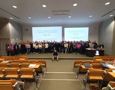 a large group of new Management Pathway students pictured in a lecture hall