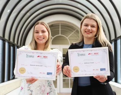 Hannah Mckeever and Rebecca Forde receive their BOC postgrad awards