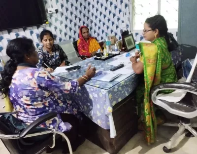 Nita meets with women around a table having a discussion