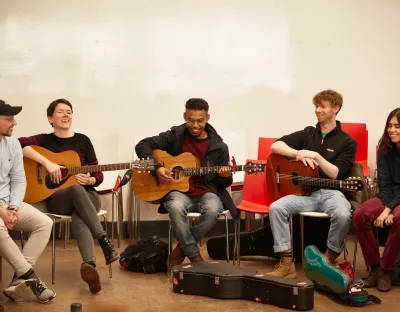 Group of musicians playing guitars in the Irish World Music Cafe