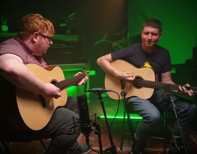 Marty Barry and Conal O’Kane playing their guitars together