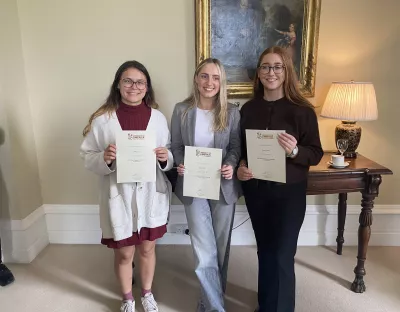 Kate Flynn, Emma Lynch and Julie Cizek holding their Lidl scholarships