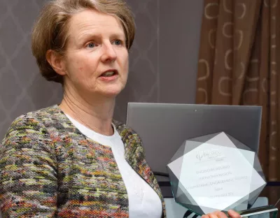 A picture of Professor Ann Ledwith, holding an award