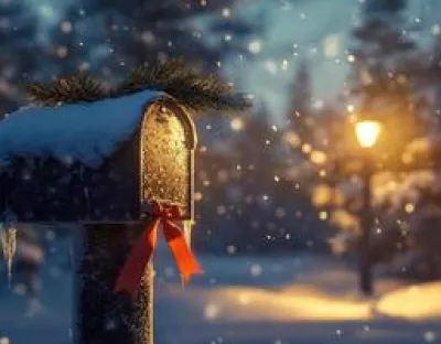 a-mailbox-covered-in-snow-and-a-red-ribbon-photo